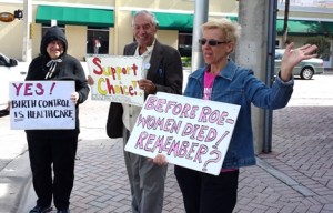 Shirley, Les and Joan advocate for Choice; Joan waves to passing drivers